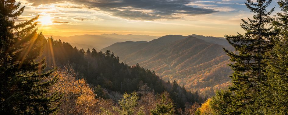 Sunrise over the mountains in Great Smoky Mountains National Park with layered ridgelines and fall foliage