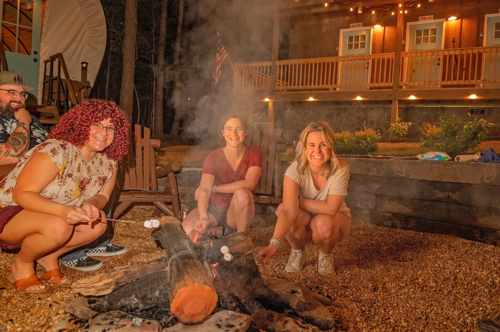 Guests roasting marshmallows around campfire at Welcome Valley Village