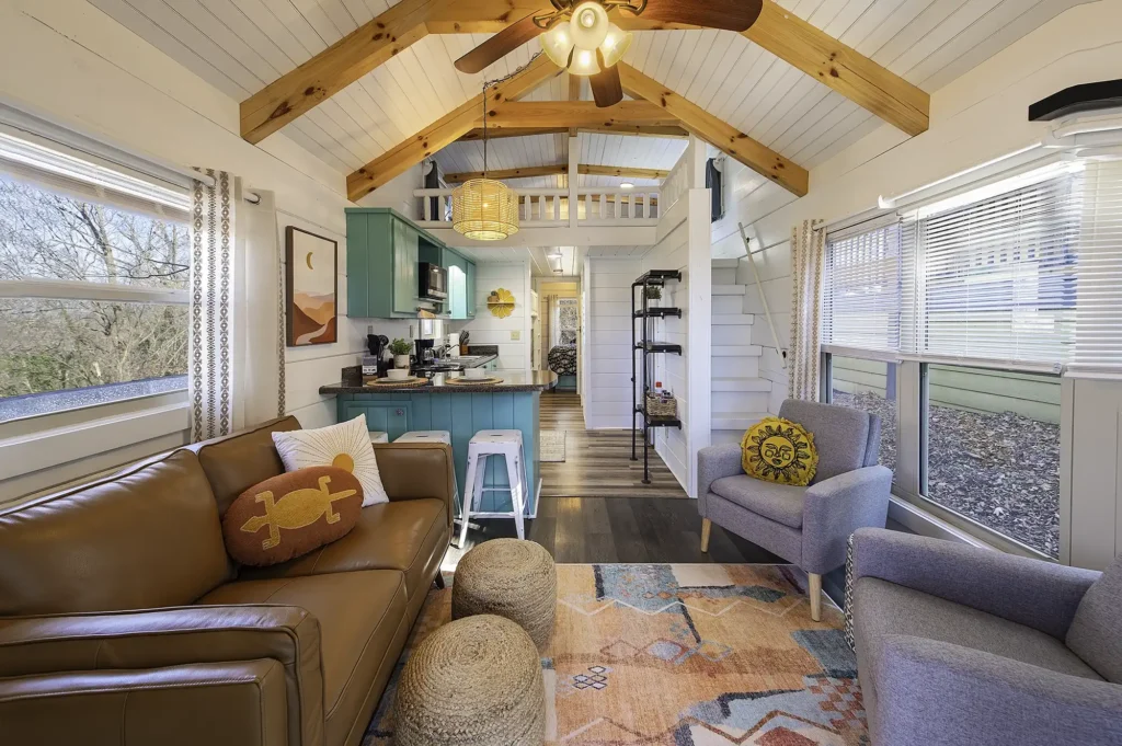 Open-concept living room and kitchen inside a tiny cabin rental at Wauhatchie Woodlands in Chattanooga