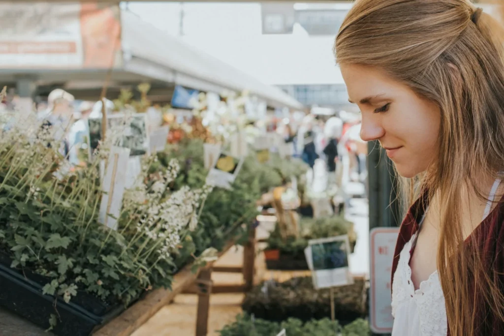 A woman looking at flowers at the Chattanooga Market